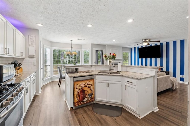 4147 Pinehurst Valley Dr, Decatur, GA 30034 - kitchen with gas range, dishwashing machine, a sink, dark wood-type flooring, and white cabinets