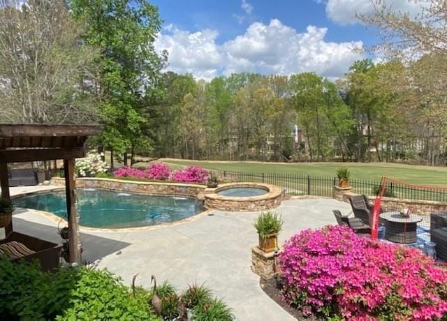 3855 Greenside Ct, Dacula, GA 30019 - view of pool with a patio, fence, and a pool with connected hot tub