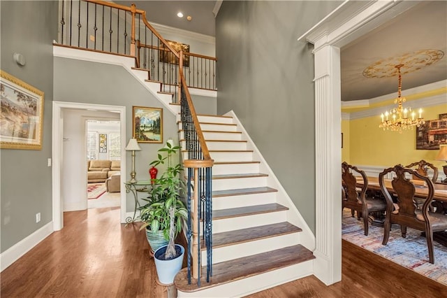 3855 Greenside Ct, Dacula, GA 30019 - stairs with crown molding, baseboards, an inviting chandelier, and wood finished floors