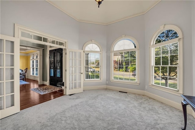 3855 Greenside Ct, Dacula, GA 30019 - carpeted foyer entrance featuring crown molding, visible vents, baseboards, a high ceiling, and french doors