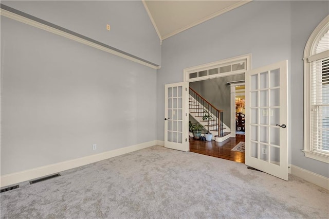 3855 Greenside Ct, Dacula, GA 30019 - empty room featuring carpet flooring, high vaulted ceiling, french doors, visible vents, and ornamental molding