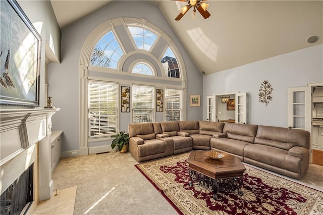3855 Greenside Ct, Dacula, GA 30019 - carpeted living area with a high end fireplace, high vaulted ceiling, baseboards, and a ceiling fan