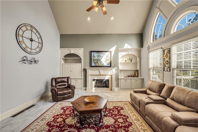 3855 Greenside Ct, Dacula, GA 30019 - living room featuring ceiling fan, a premium fireplace, high vaulted ceiling, carpet, and baseboards