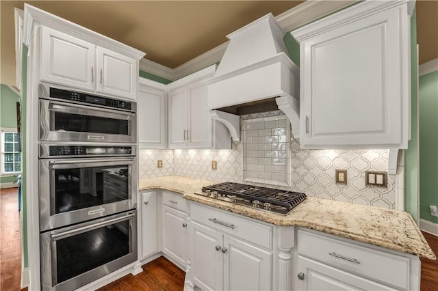 3855 Greenside Ct, Dacula, GA 30019 - kitchen featuring appliances with stainless steel finishes, decorative backsplash, dark wood finished floors, and white cabinetry