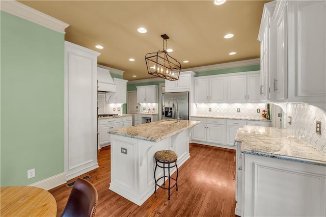 3855 Greenside Ct, Dacula, GA 30019 - kitchen featuring crown molding, white cabinetry, and appliances with stainless steel finishes