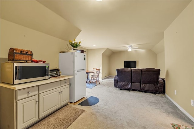 3855 Greenside Ct, Dacula, GA 30019 - kitchen with ceiling fan, a toaster, stainless steel microwave, freestanding refrigerator, and light carpet