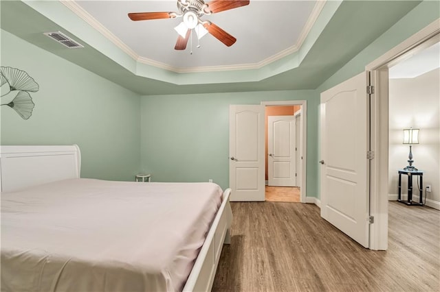 3855 Greenside Ct, Dacula, GA 30019 - bedroom with a raised ceiling, ornamental molding, wood finished floors, and visible vents