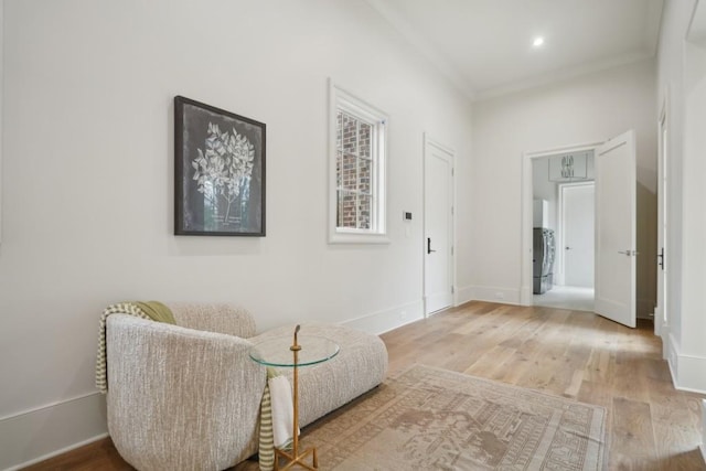 sitting room featuring crown molding and hardwood / wood-style flooring