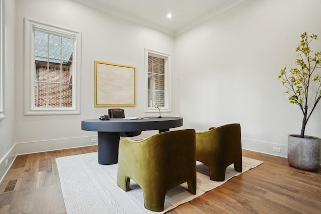 office with hardwood / wood-style flooring and ornamental molding