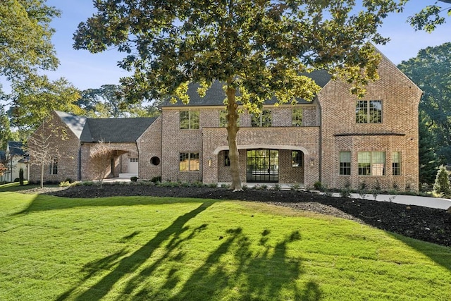 tudor home with a front lawn