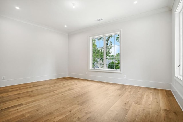 unfurnished room with light hardwood / wood-style floors and ornamental molding