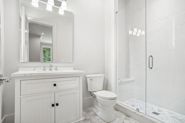 bathroom featuring vanity, toilet, and a shower with shower door