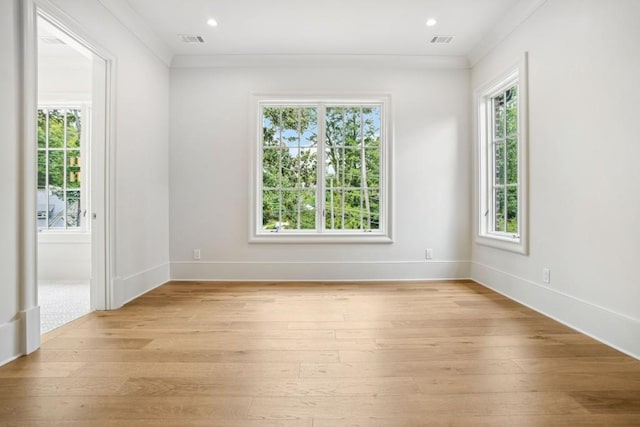 unfurnished room featuring light wood-type flooring and ornamental molding