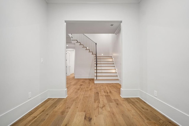 staircase with hardwood / wood-style flooring