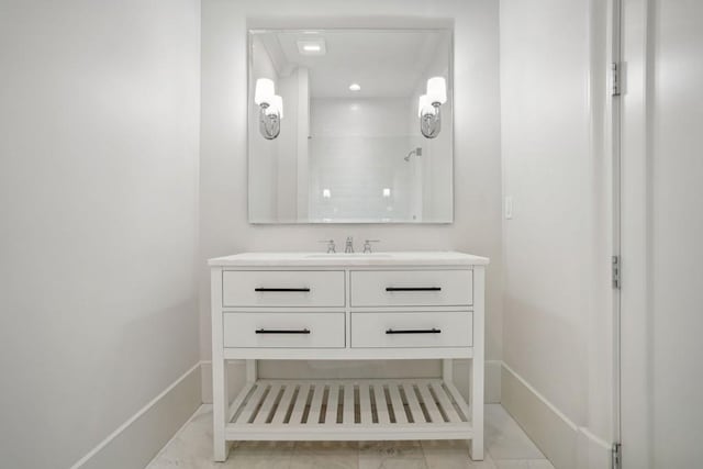 bathroom featuring tile patterned flooring, vanity, and a shower