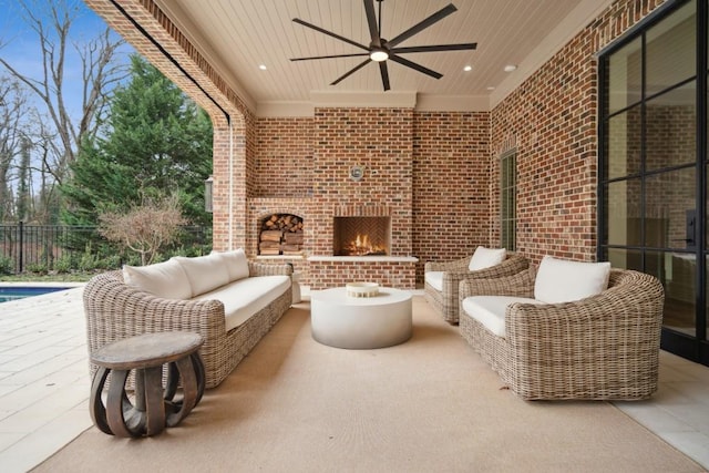 view of patio / terrace featuring ceiling fan and an outdoor brick fireplace