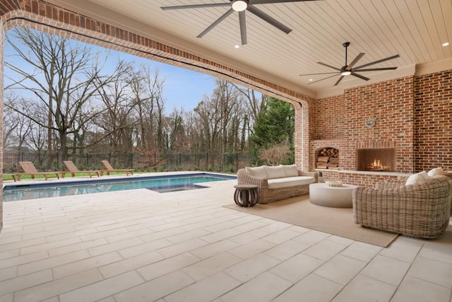 view of patio with an outdoor living space with a fireplace