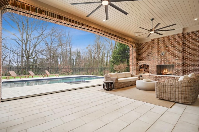 view of patio featuring an outdoor living space with a fireplace