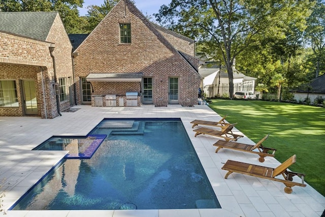 view of pool with area for grilling, a patio area, and a yard