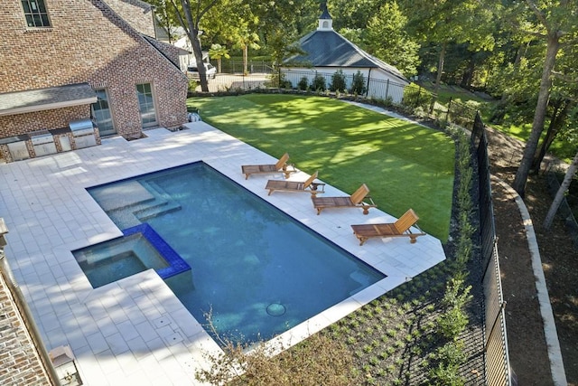 view of pool featuring a patio area, an in ground hot tub, and exterior kitchen