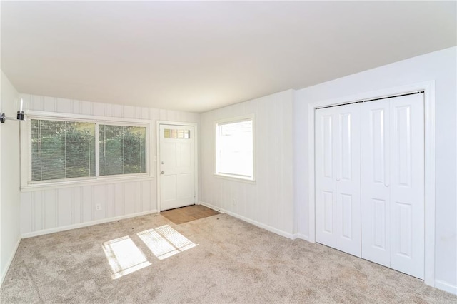 unfurnished bedroom with a closet and carpet flooring