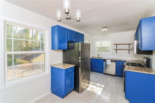 kitchen featuring light stone counters, open shelves, appliances with stainless steel finishes, blue cabinets, and a chandelier