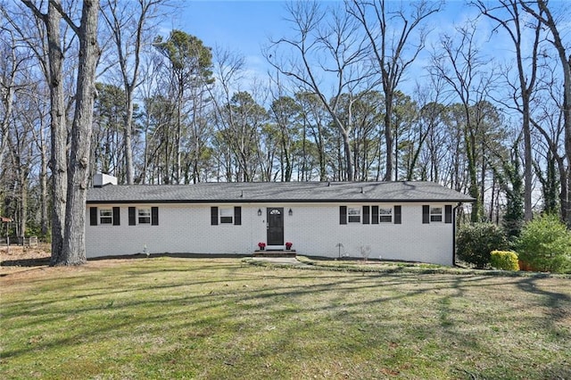 ranch-style house featuring brick siding and a front yard