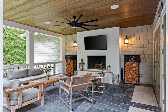 sunroom / solarium featuring a fireplace, wood ceiling, and a ceiling fan