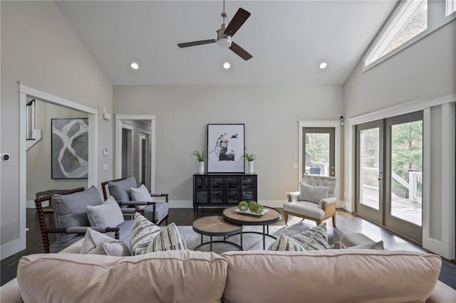 living area with high vaulted ceiling, recessed lighting, wood finished floors, baseboards, and french doors