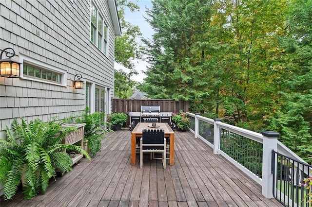 deck with outdoor dining area, fence, an outdoor living space, and area for grilling