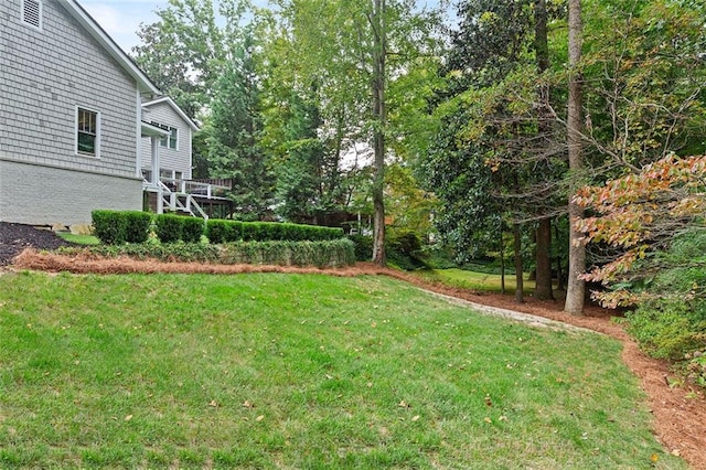 view of yard featuring a wooden deck