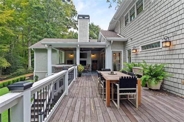 wooden terrace with outdoor dining space