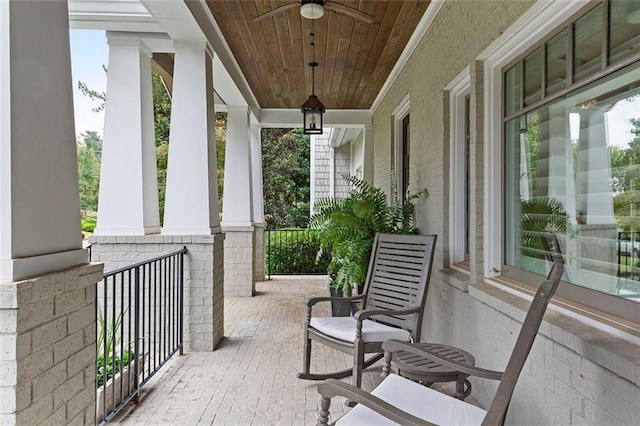 balcony with covered porch and ceiling fan