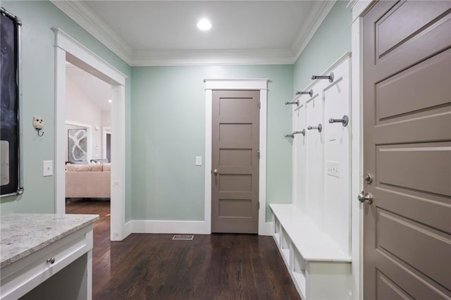 mudroom featuring dark wood finished floors, crown molding, baseboards, and recessed lighting