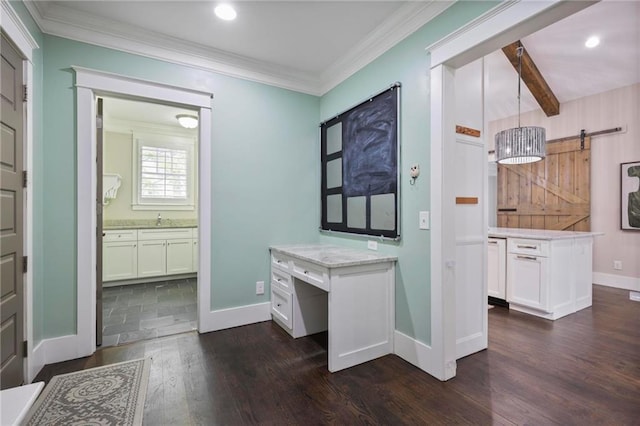 interior space featuring crown molding, dark wood finished floors, a barn door, white cabinetry, and a sink