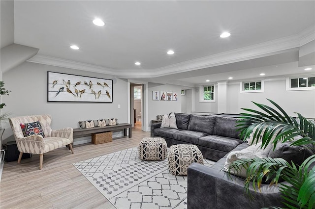 living room with light wood-style floors, ornamental molding, and recessed lighting