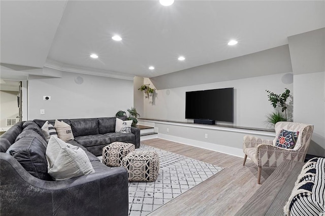 living room featuring baseboards, wood finished floors, and recessed lighting