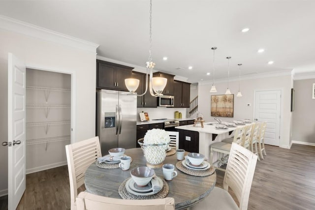 dining room with baseboards, dark wood-style flooring, crown molding, and recessed lighting