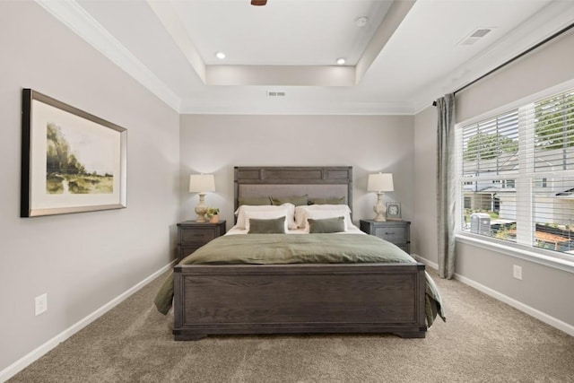 bedroom with a tray ceiling, light carpet, visible vents, and baseboards