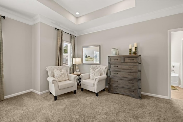 sitting room with recessed lighting, light colored carpet, baseboards, ornamental molding, and a tray ceiling