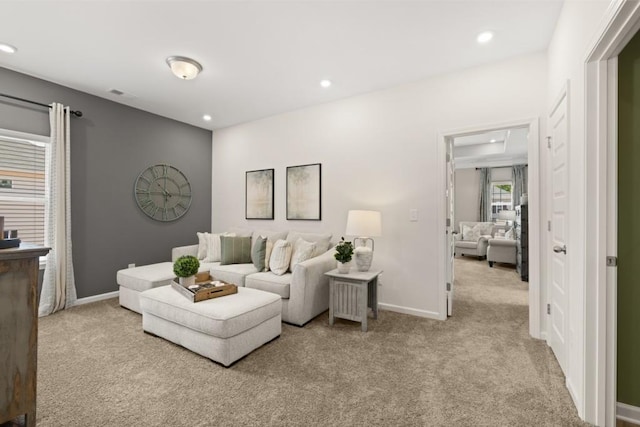 living area featuring light carpet, recessed lighting, visible vents, and baseboards