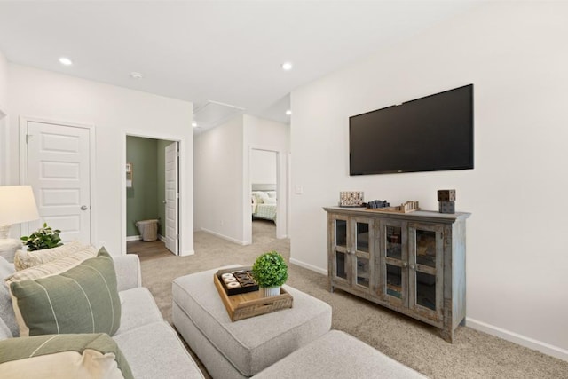 living area with recessed lighting, light colored carpet, and baseboards