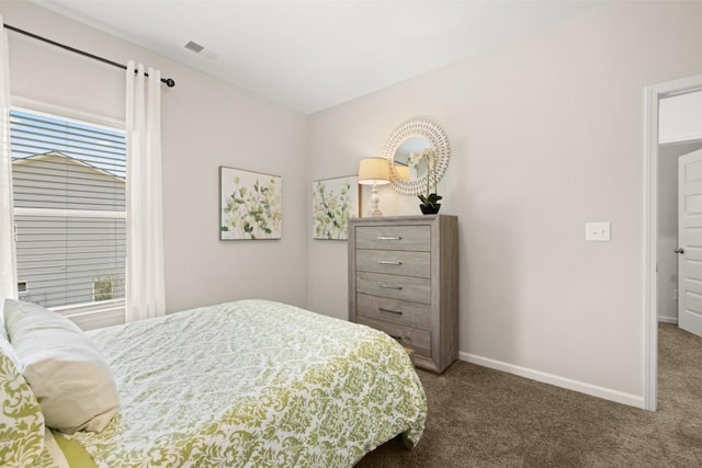 bedroom featuring baseboards, visible vents, and dark carpet