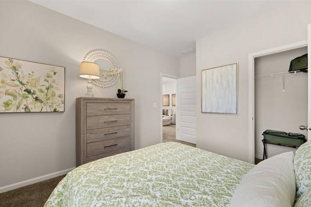 carpeted bedroom with a closet and baseboards