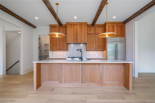 kitchen with built in fridge, beamed ceiling, backsplash, light countertops, and a spacious island