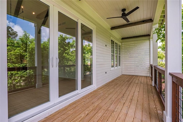 deck with a ceiling fan, french doors, and covered porch