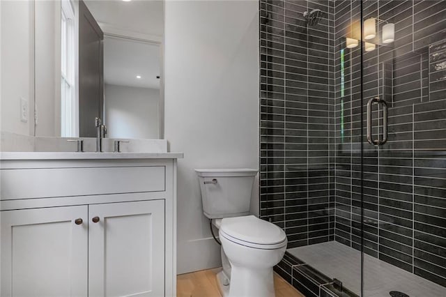 full bath with a stall shower, vanity, and toilet
