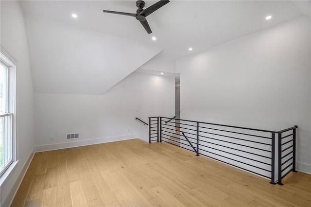 bonus room with wood finished floors, healthy amount of natural light, ceiling fan, recessed lighting, and baseboards