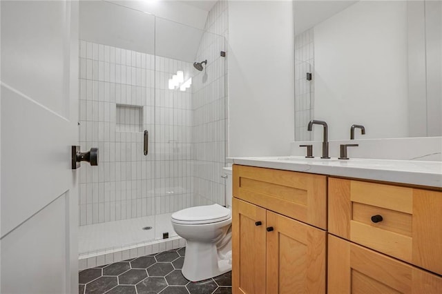 bathroom with a shower stall, toilet, tile patterned floors, and vanity