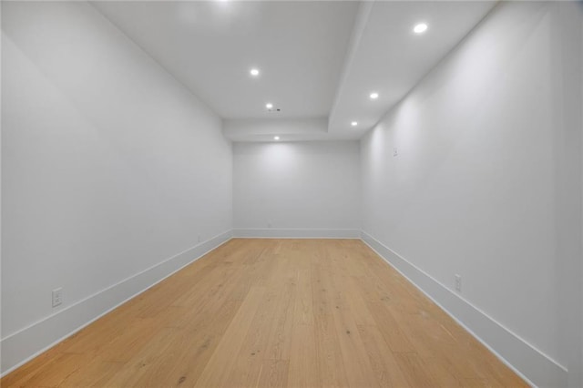 empty room with recessed lighting, light wood-style flooring, and baseboards